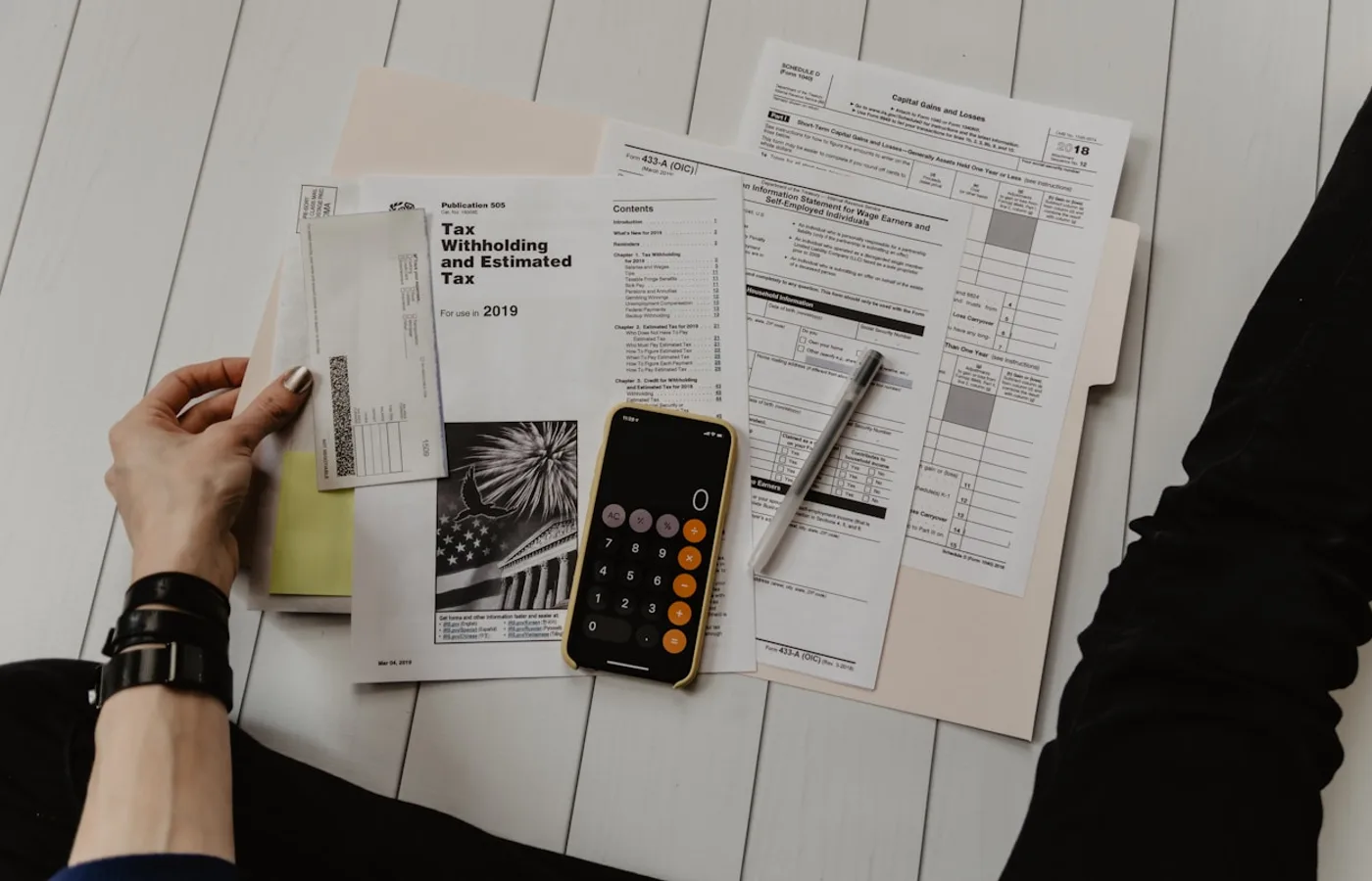 Tax documents and calculator on a desk