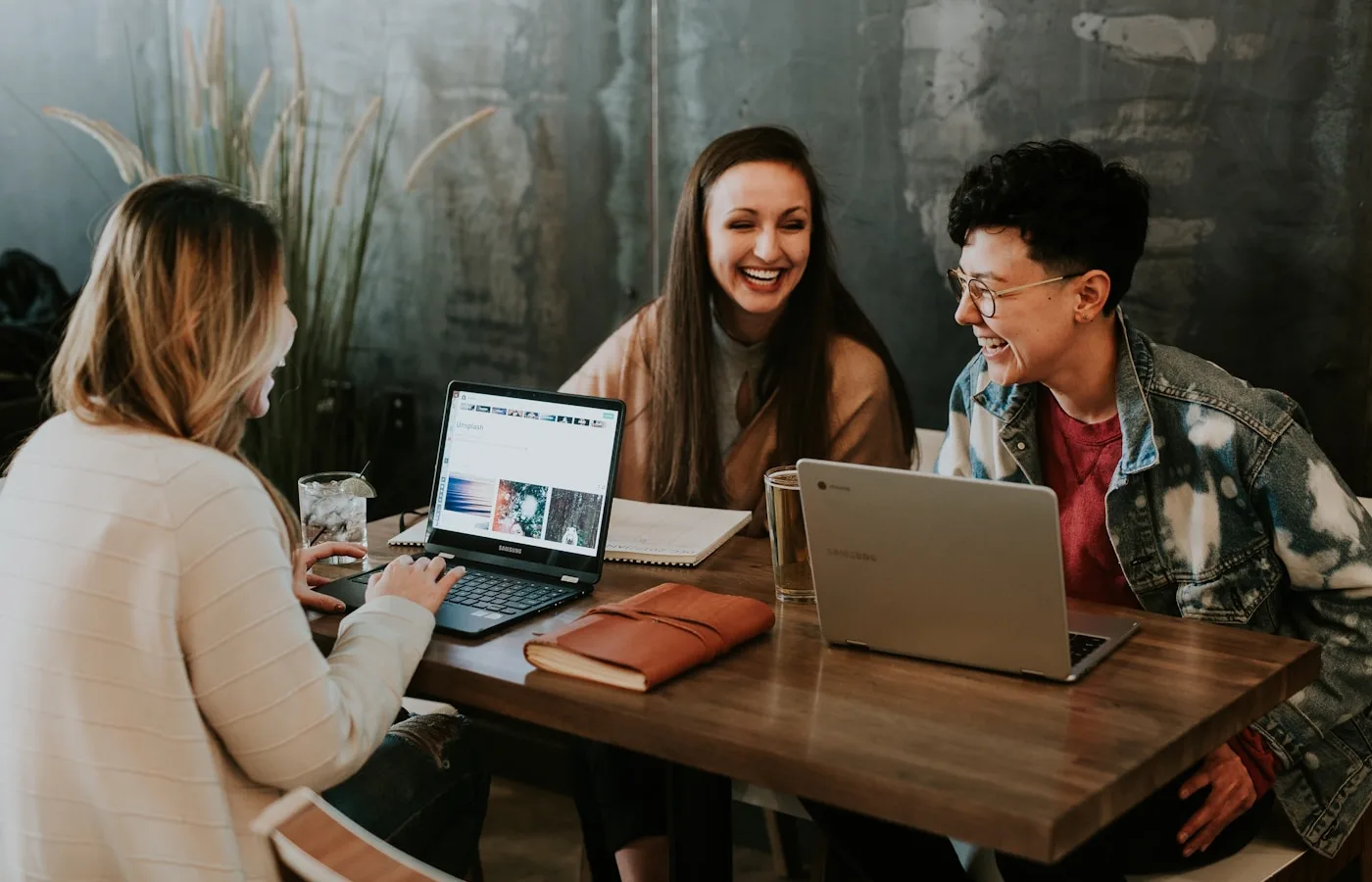 Marketing agency team collaborating around a laptop